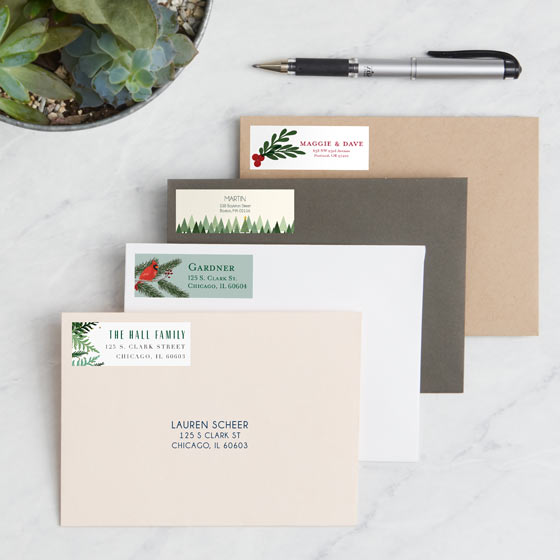 Address Labels with Holiday Themed Designs displayed on an array of envelopes