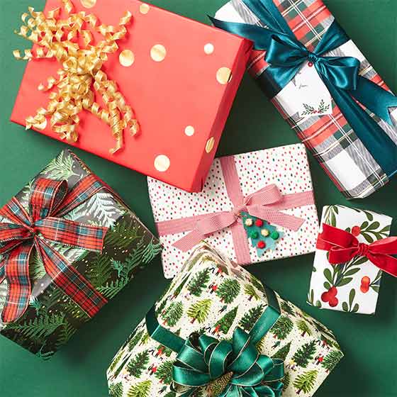 Assorted gifts wrapped in holiday themed wrapping paper