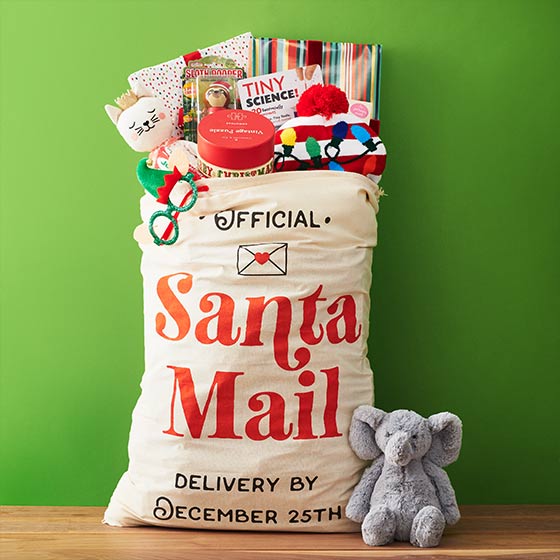 Gifts spilling out of a bag that says Santa Mail